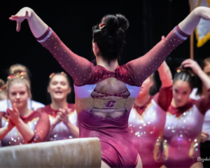 CMU gymnast Sierra Demarinis salutes after balance beam routine