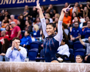 Mia Takekawa from the University of Illinois salutes after balance beam at the Seattle regional