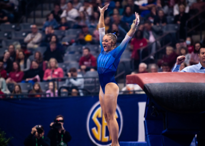 Savannah Schoenherr salutes to the judge with a smile on her face after finishing her vault