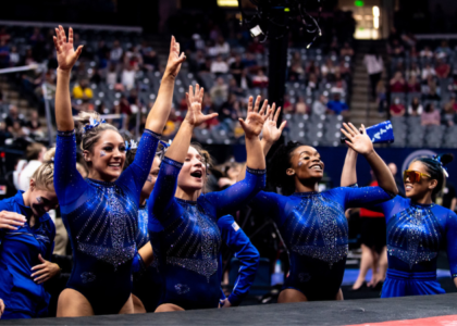 Kentucky gymnasts cheer for their teammate after a routine