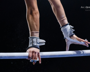 a gymnast performing a pirouette on bars