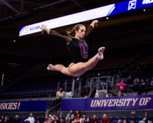 Chloe Widner hits an oversplit on a leap on beam
