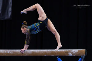 Natallie Wojcik competes on beam for Michigan.