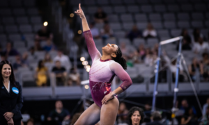 Lynnzee Brown points to the sky at the end of her floor routine