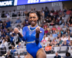 Selena Harris performs choreography during her floor routine while facing the camera