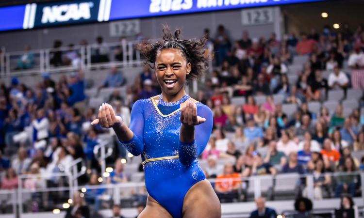 Selena Harris performs choreography during her floor routine while facing the camera