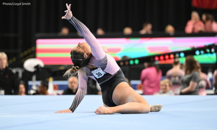 Skylar Draser poses on floor with her right arm to the sky.