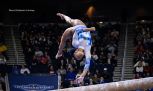 Trinity Thomas performs a one-handed back handspring on balance beam