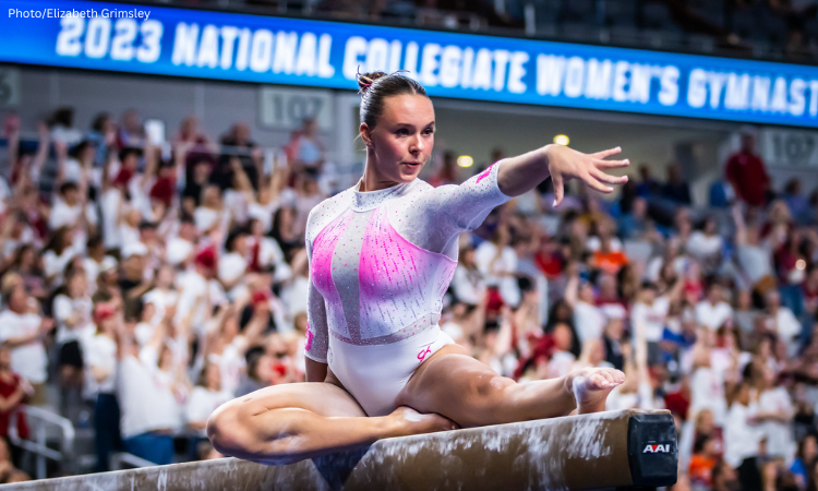 Maile O'Keefe poses on beam and flairs her wrist