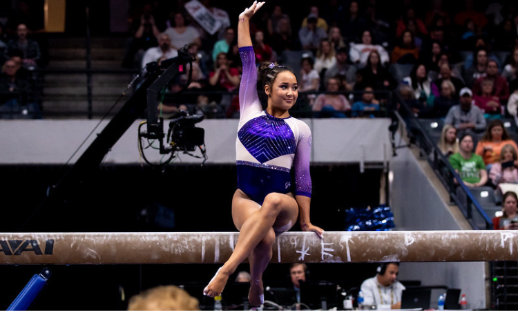 Aleah Finnegan performs on beam