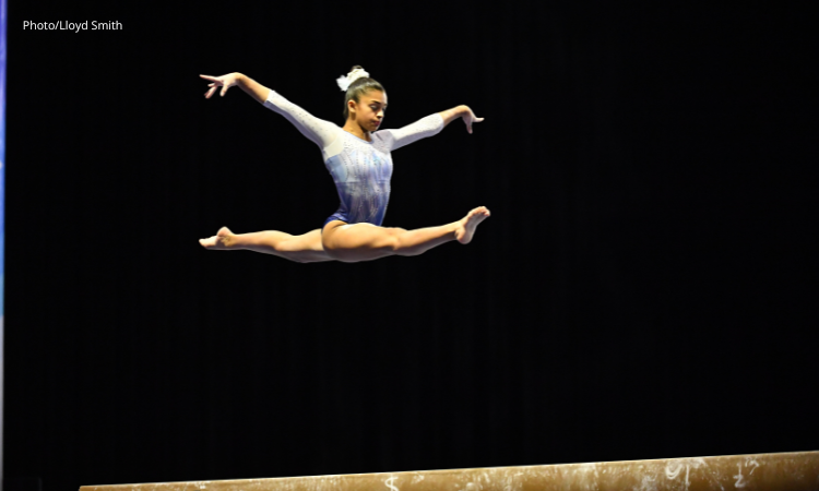 Tiana Sumanasekera performs a split jump on beam