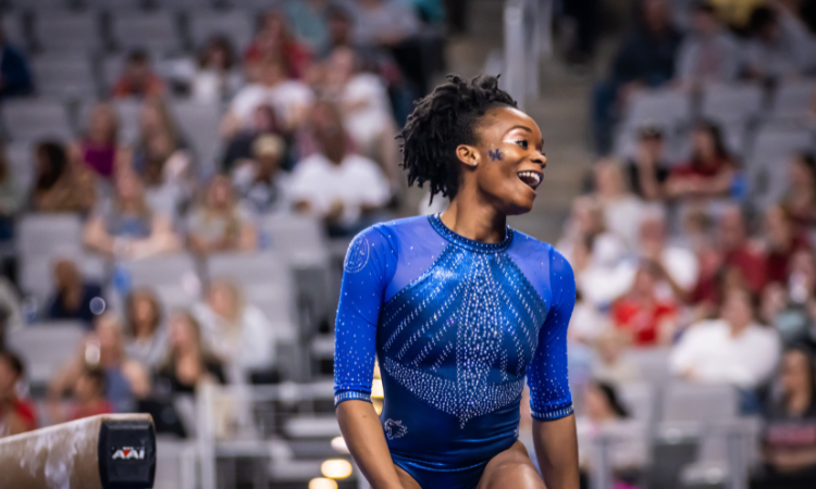 Arianna Patterson smiling near beam