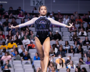 Adeline Kenlin finishing a skill on balance beam at the 2022 NCAA Nationals Championships.