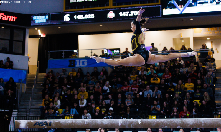 Adeline Kenlin competes on beam for Iowa.