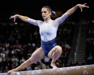 Cassie Stevens on beam completing a wolf turn.