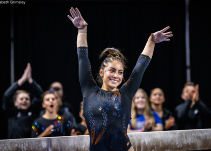 Emily Lopez salutes after a beam routine for Boise State.