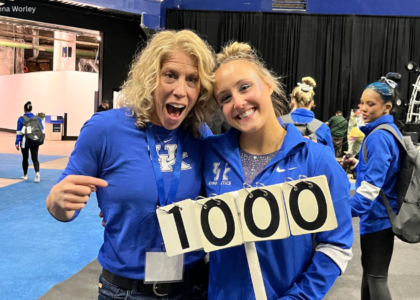 Jenny Hansen Hecht and Raena Worley stand with the perfect 10 sign
