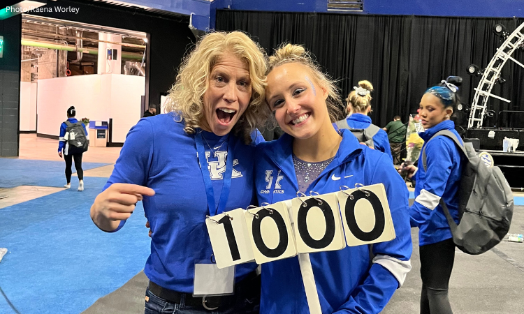 Jenny Hansen Hecht and Raena Worley stand with the perfect 10 sign