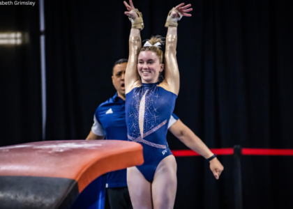 Kendall Whitman salutes after a vault.