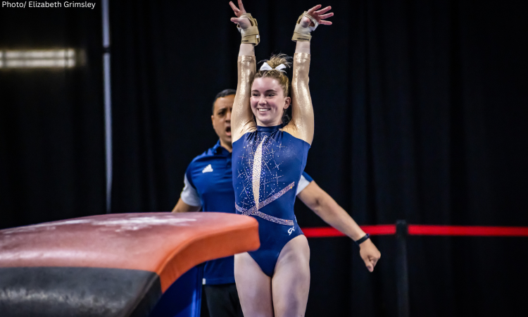 Kendall Whitman salutes after a vault.