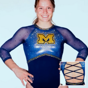 Front and back view of Michigan's new gymnastics leotard. The design features a bold maize "M" on a glittering navy blue body with scattered gold and silver rhinestones. The neckline and sleeves are sheer navy mesh adorned with crystals. The back showcases an open crisscross lace-up pattern framed by shimmering details.