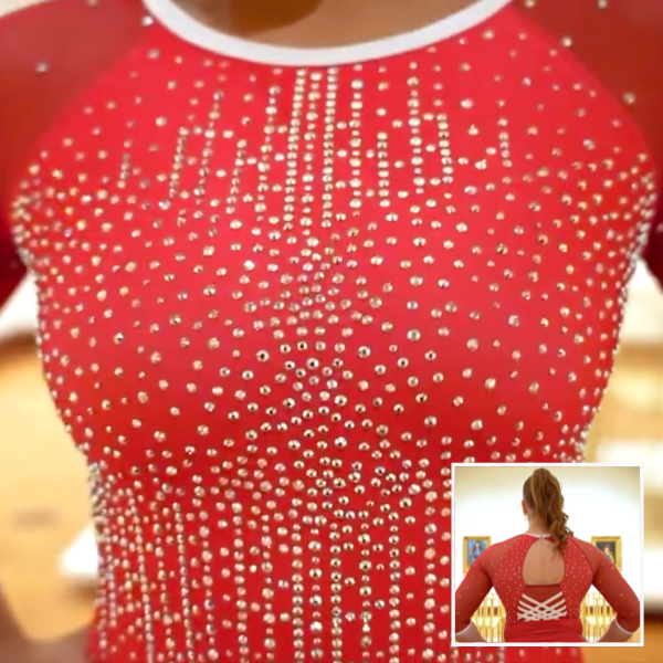A close-up of a red gymnastics leotard adorned with sparkling rhinestones arranged in a cascading pattern. The inset image in the lower right corner shows the back of the leotard, which features an open-back design with crisscrossing straps.