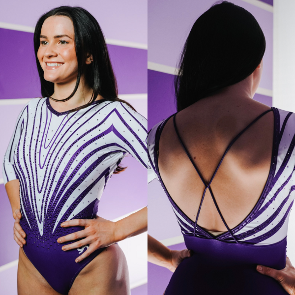 A Clemson gymnast showcases the team’s new leotard, featuring bold purple lines, outlined with rhinestones, create a dynamic, flame-like pattern across the front, converging at the waist. The leotard has three-quarter length sleeves with matching line detailing. The back reveals a deep V-cut with delicate crisscrossing purple straps for added elegance.