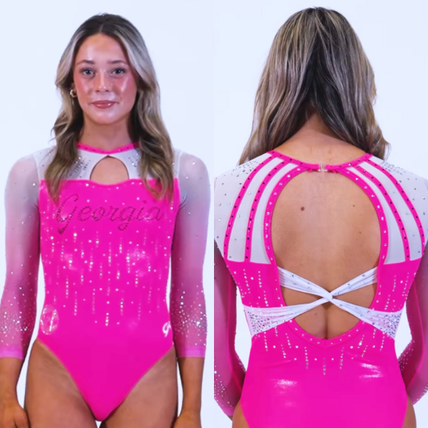 A gymnast from Georgia wearing a hot pink leotard with glittery silver accents. The leotard features a white diagonal stripe design across the upper chest and a keyhole cutout on the front and back. The word "Georgia" is bedazzled across the front in silver rhinestones, adding to the bold, sparkling effect.