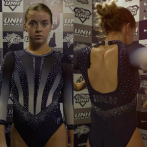A navy blue and silver leotard worn by a New Hampshire gymnast. The front features a sleek ombre design with silver and white accents creating a sharp, modern look, enhanced by rhinestone detailing. The neckline is adorned with a crystal choker effect, and the sleeves are sheer with scattered rhinestones. The back showcases an open keyhole design with "UNH" spelled in rhinestones across the lower back, with additional sparkling details along the edges.