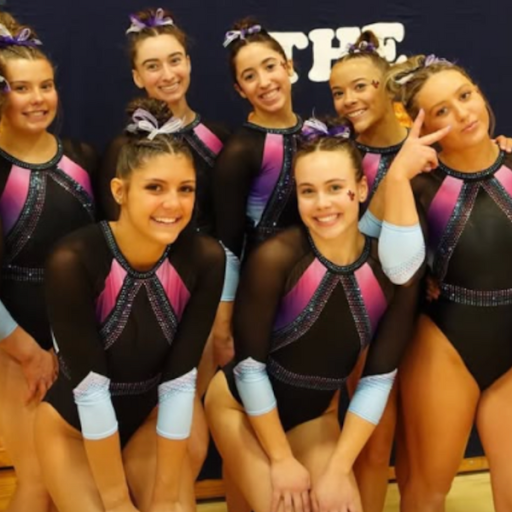 Simpson in a black leotard with light pink detailing towards the top and pastel blue sleeves