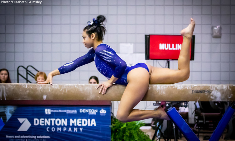 Serena Mullin performs choreography on the balance beam.