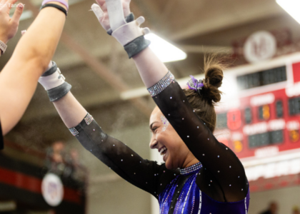 Estee Flom high-fives after bars