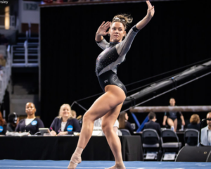 Jaylene Gilstrap performs choreography on floor.