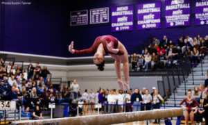Olivia Keyes is in mid-air arch on beam
