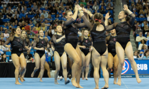The Stanford teams celebrates and high-fives Anna Roberts.