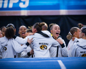 Missouri gymnasts hug and cheer at the nationals award ceremony