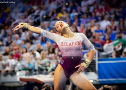 Elle Mueller poses with one hand on her hip and the other outstretched on floor for Oklahoma.