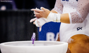 gymnast chalking up for bars