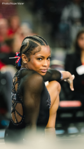Nyla Aquino strikes a fierce pose on floor and stares directly at the camera