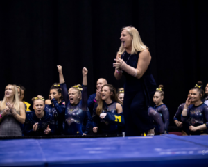 Michigan women's gymnatics head coach Bev Plocki celebrating at the 2019 NCAA Championships