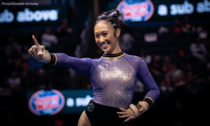 Kailin Chio LSU making an L with her fingers during her floor routine
