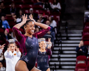 Noelle Adams poses with her hands in the shape of a crown during her floor routine.