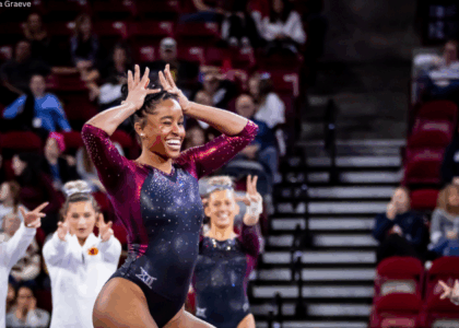 Noelle Adams poses with her hands in the shape of a crown during her floor routine.