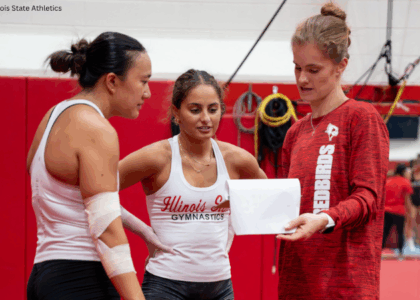 Illinois State head coach Cassandra Ringer speaks to two athletes