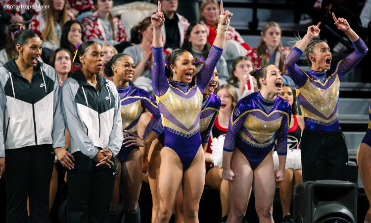The LSU gymnastics team celebrates from the sidelines.