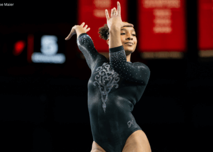 CaMarah Williams dances on floor poses her hands with wrists flexed by her face.