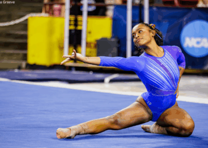 Selena Harris-Miranda of Florida poses sitting on the floor with one arm and one leg extended to the side.