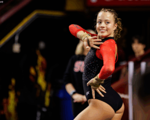 Berlin Hall of Southern Utah University poses on floor with a smile.