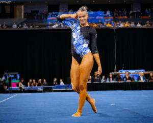 Creslyn Brose does her "phone" pose on floor, holding one hand up to her ear.