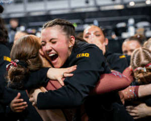 Minnesota gymnasts embrace after qualifying to the national final.
